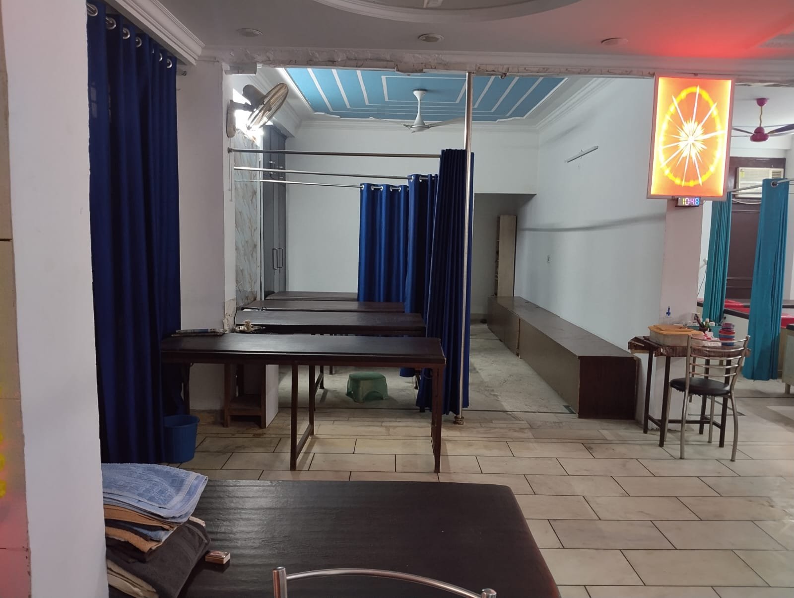Naturopathy treatment section with tables and blue curtains