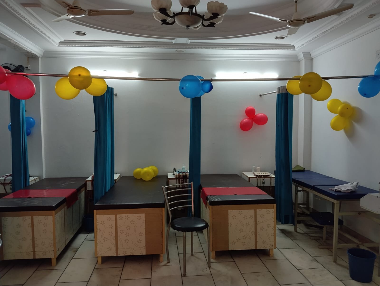 Therapy hall with treatment beds separated by curtains
